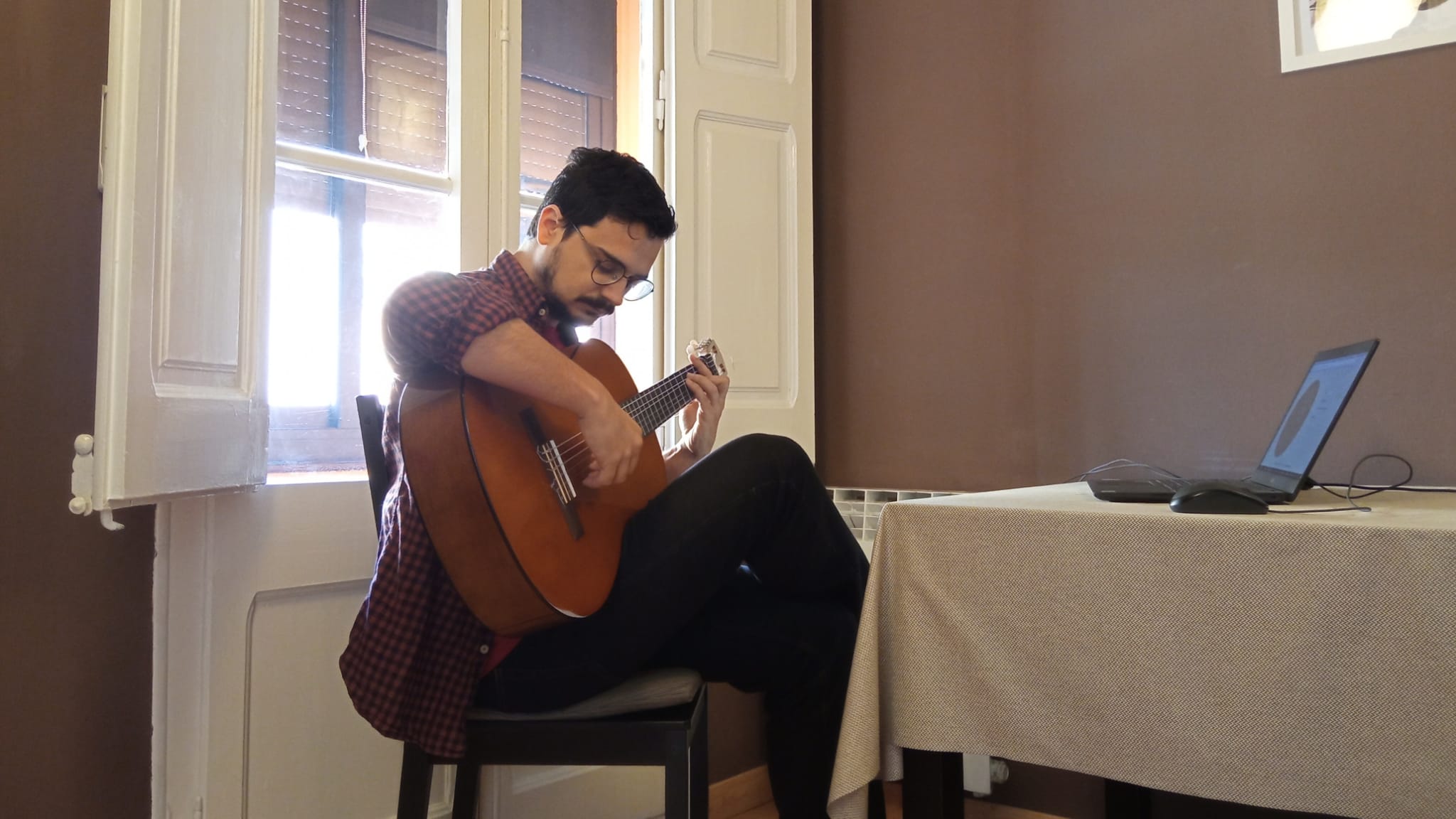 Me, practicing flamenco guitar with the metronome.